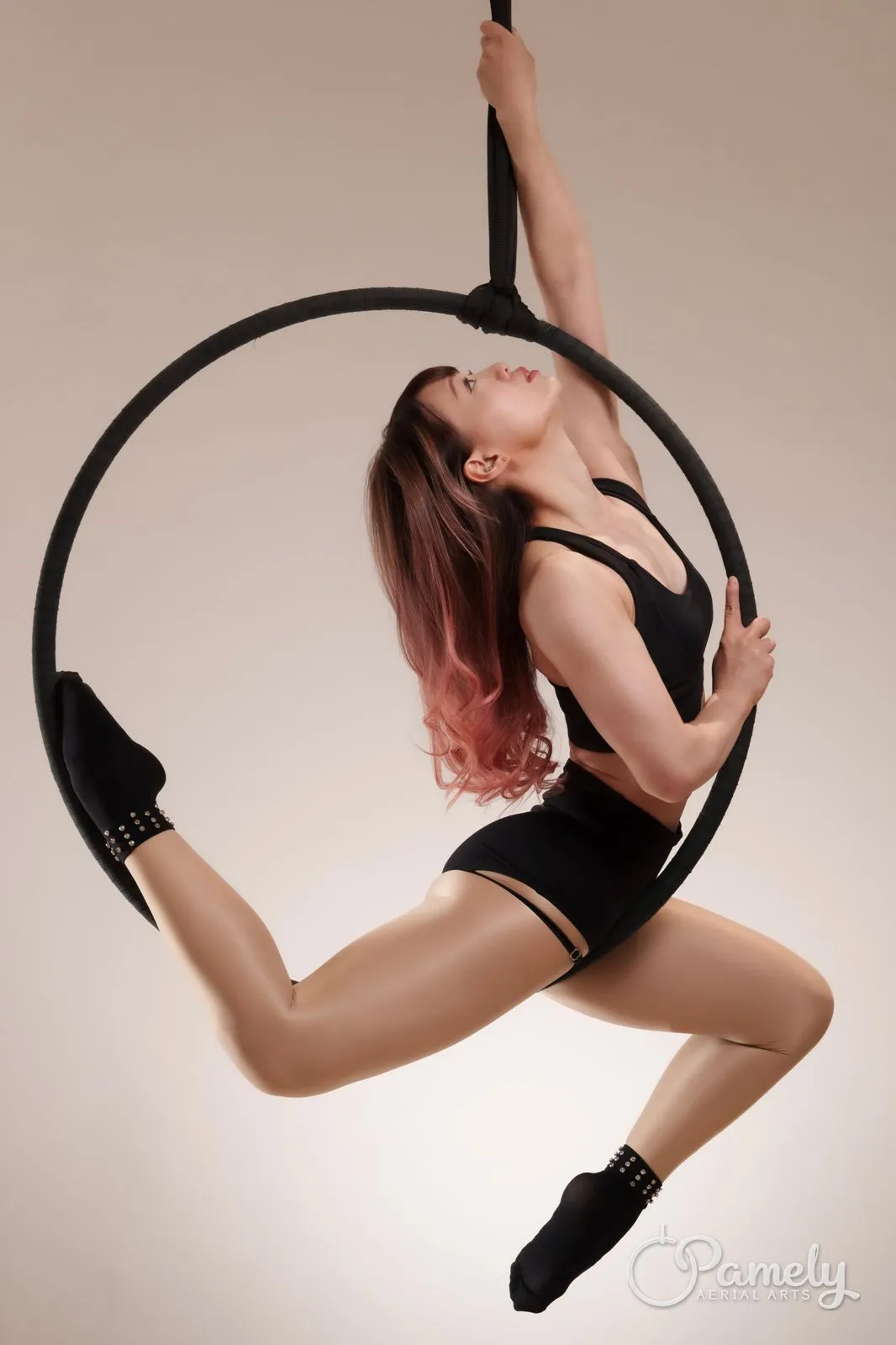 Pamely in a split pose inside the hoop