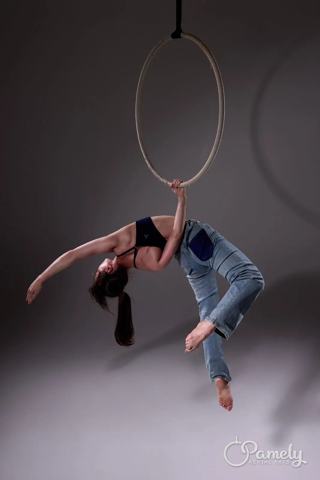 Pamely inverted in the hoop against a grey backdrop