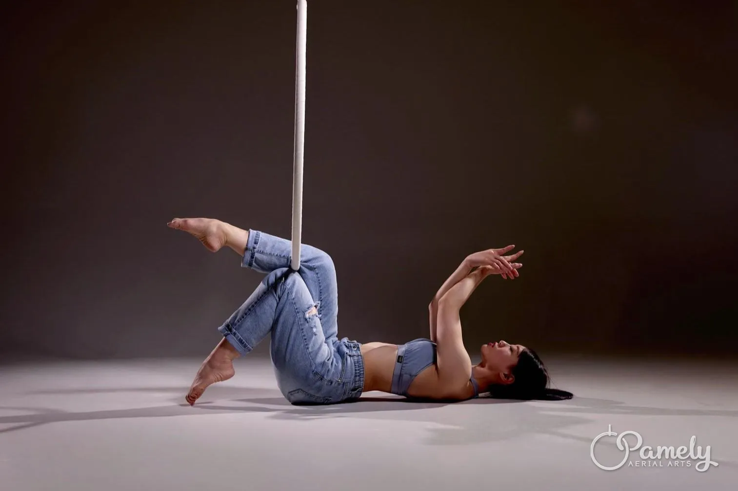 Pamely posing on the floor beneath a hoop