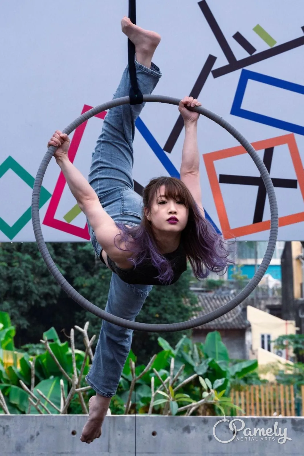 Pamely hanging from a hoop at an outdoor performance
