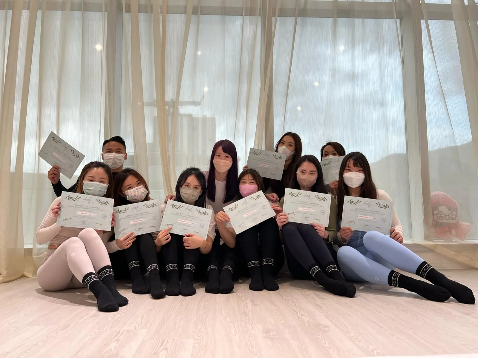 Graduating class with certificates